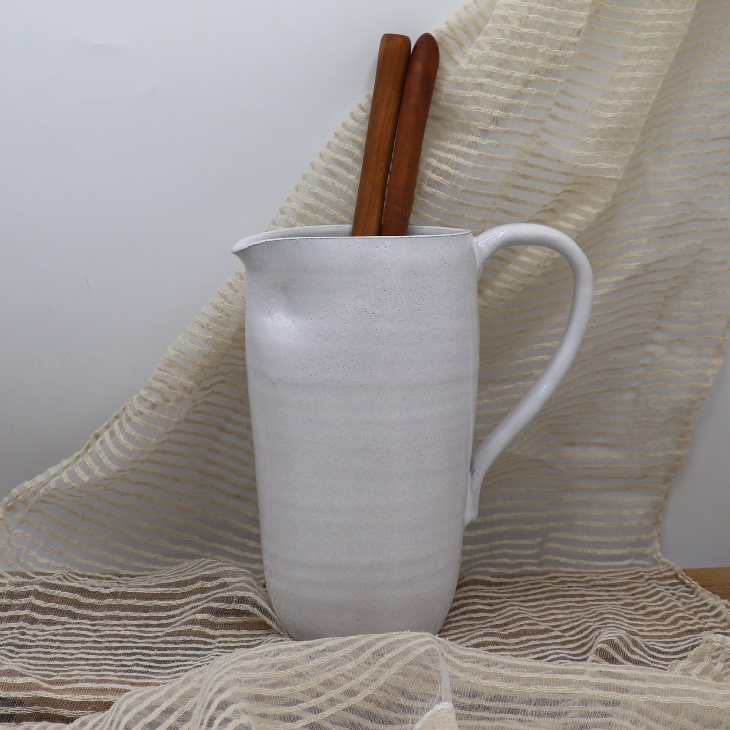 Grey clay pitcher in white