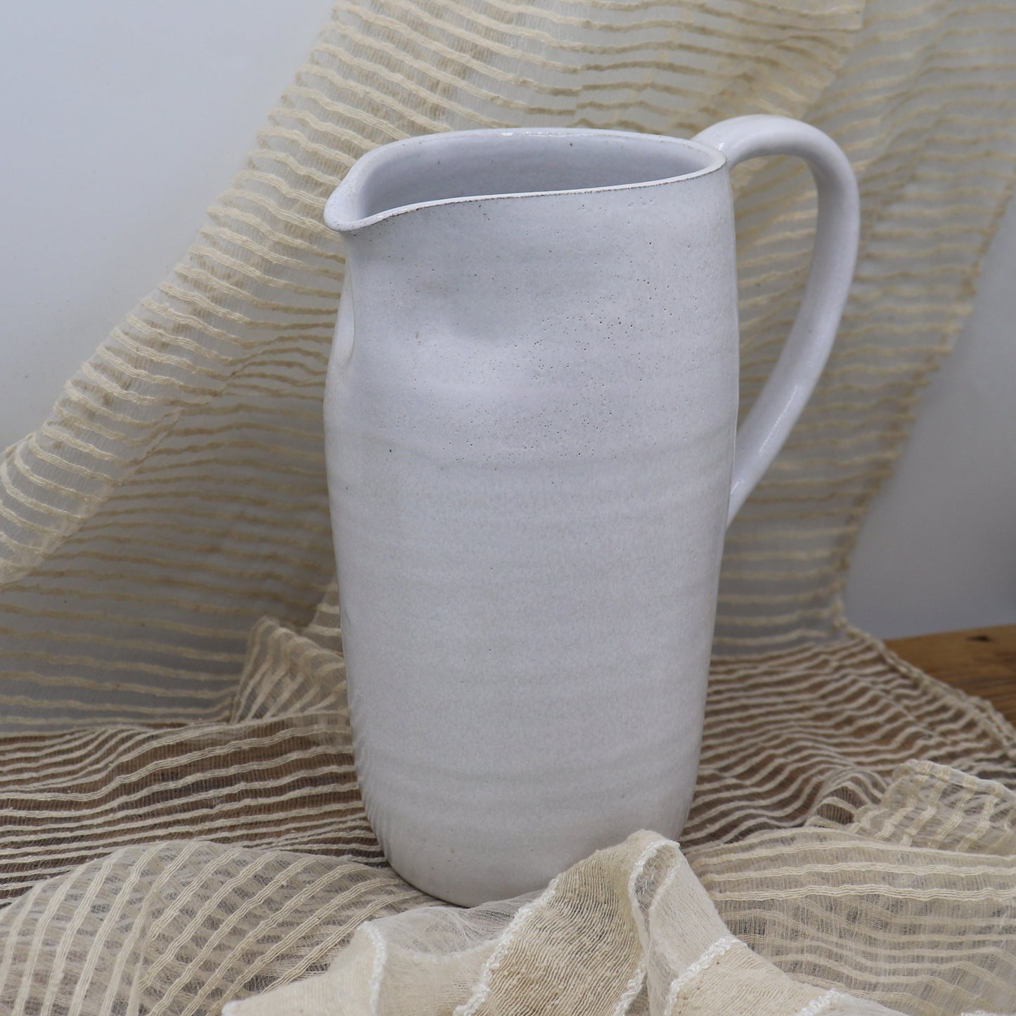 Grey clay pitcher in white