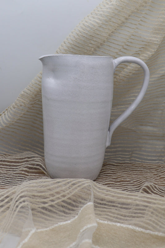 Grey clay pitcher in white