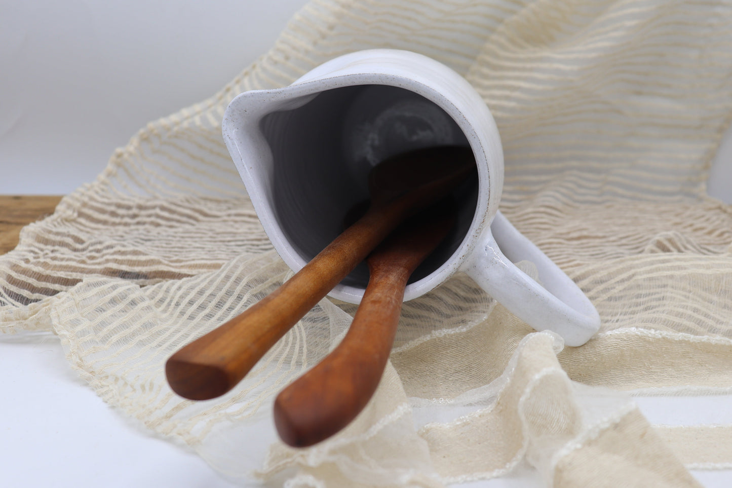 Grey clay pitcher in white