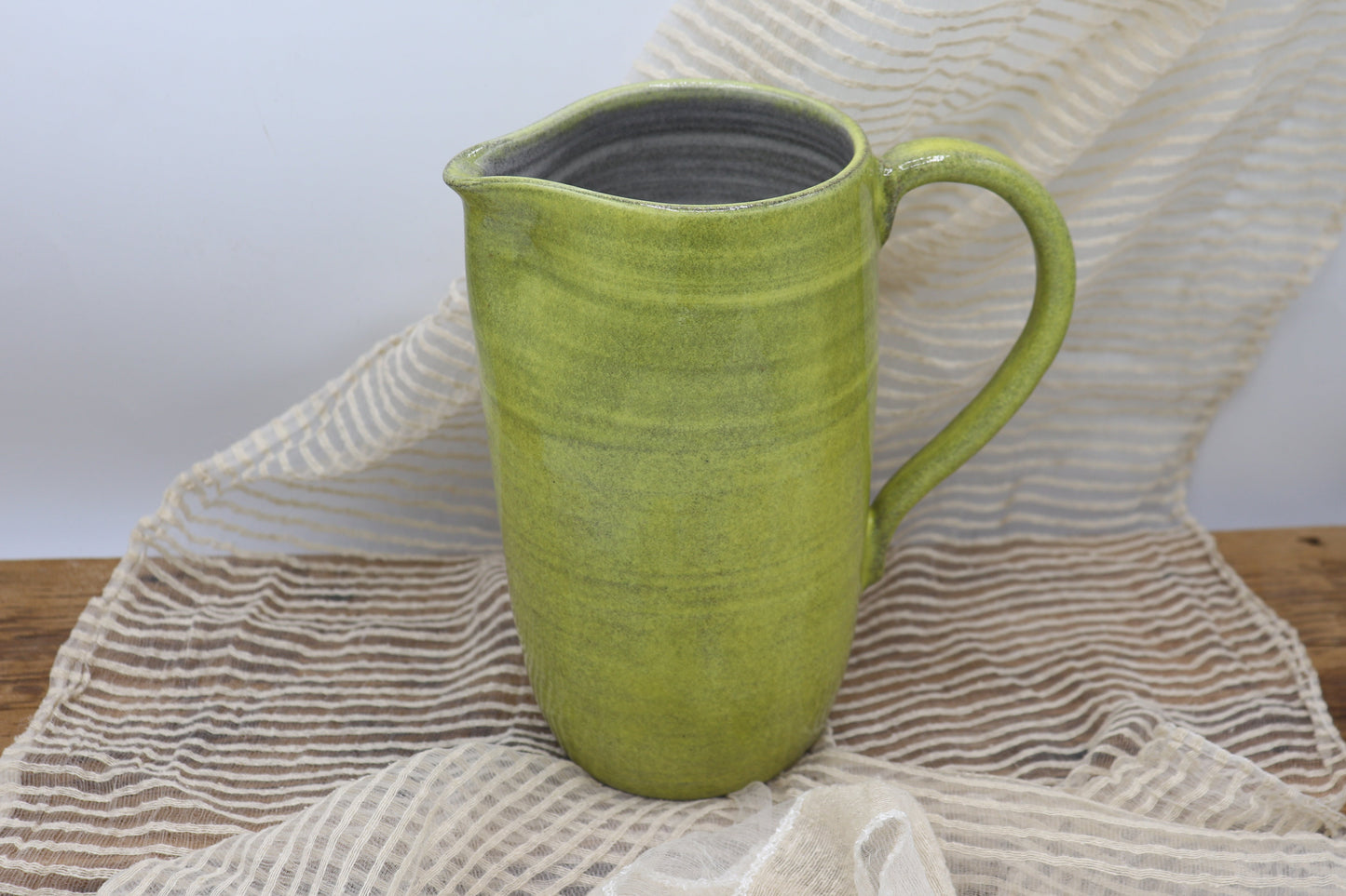 Grey clay pitcher in yellow