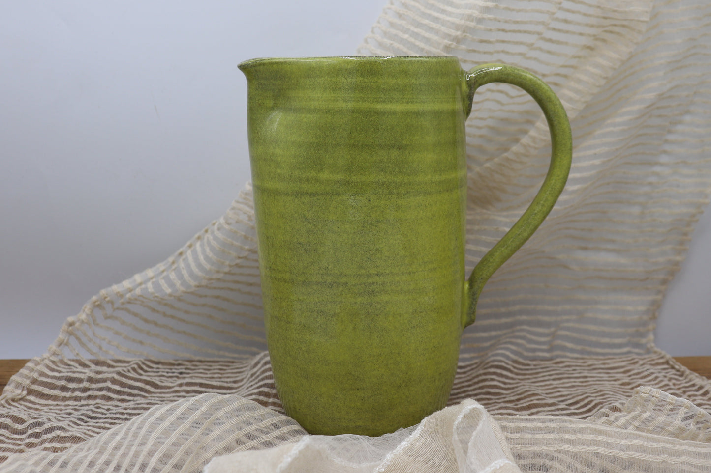 Grey clay pitcher in yellow