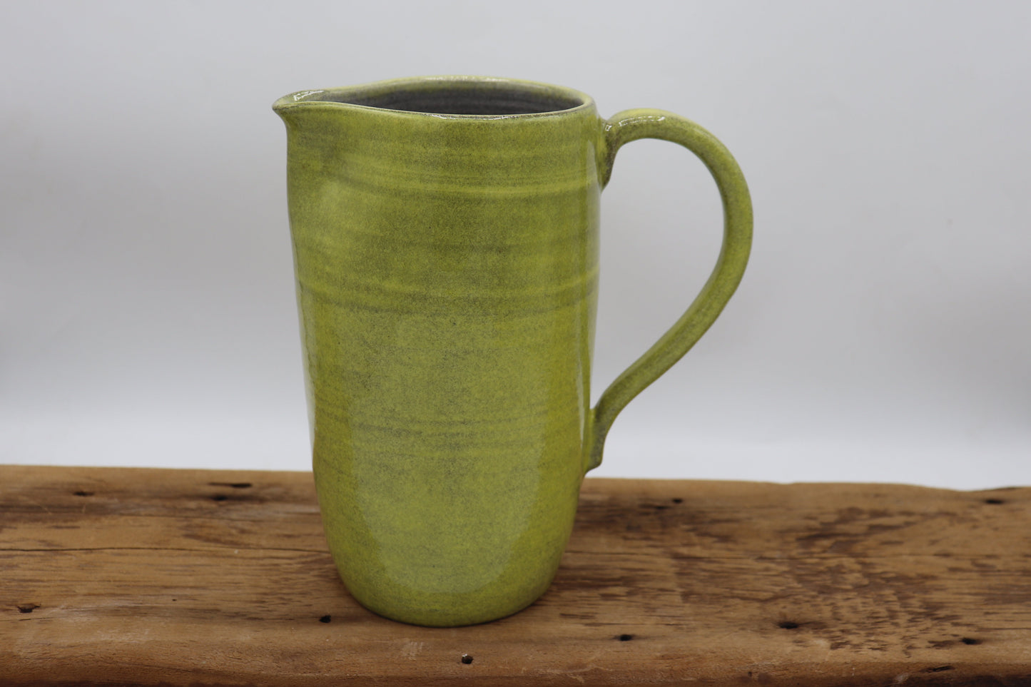 Grey clay pitcher in yellow