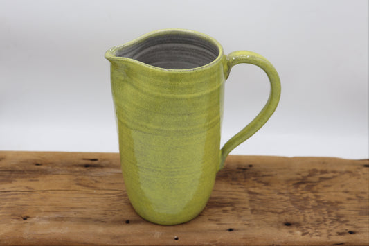 Grey clay pitcher in yellow