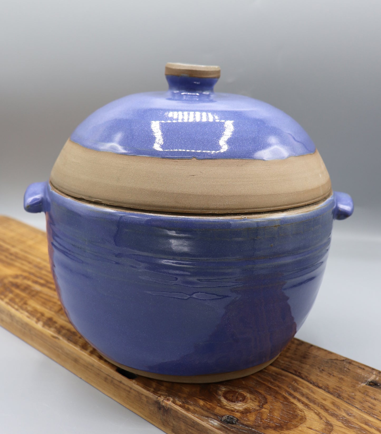 Blue-glazed stoneware casserole dish with lid