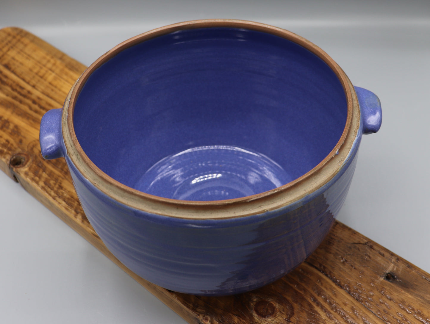 Blue-glazed stoneware casserole dish with lid